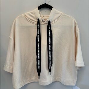 Alo Yoga Air Land Ocean short-sleeve crop hoodie in a cream/ivory color